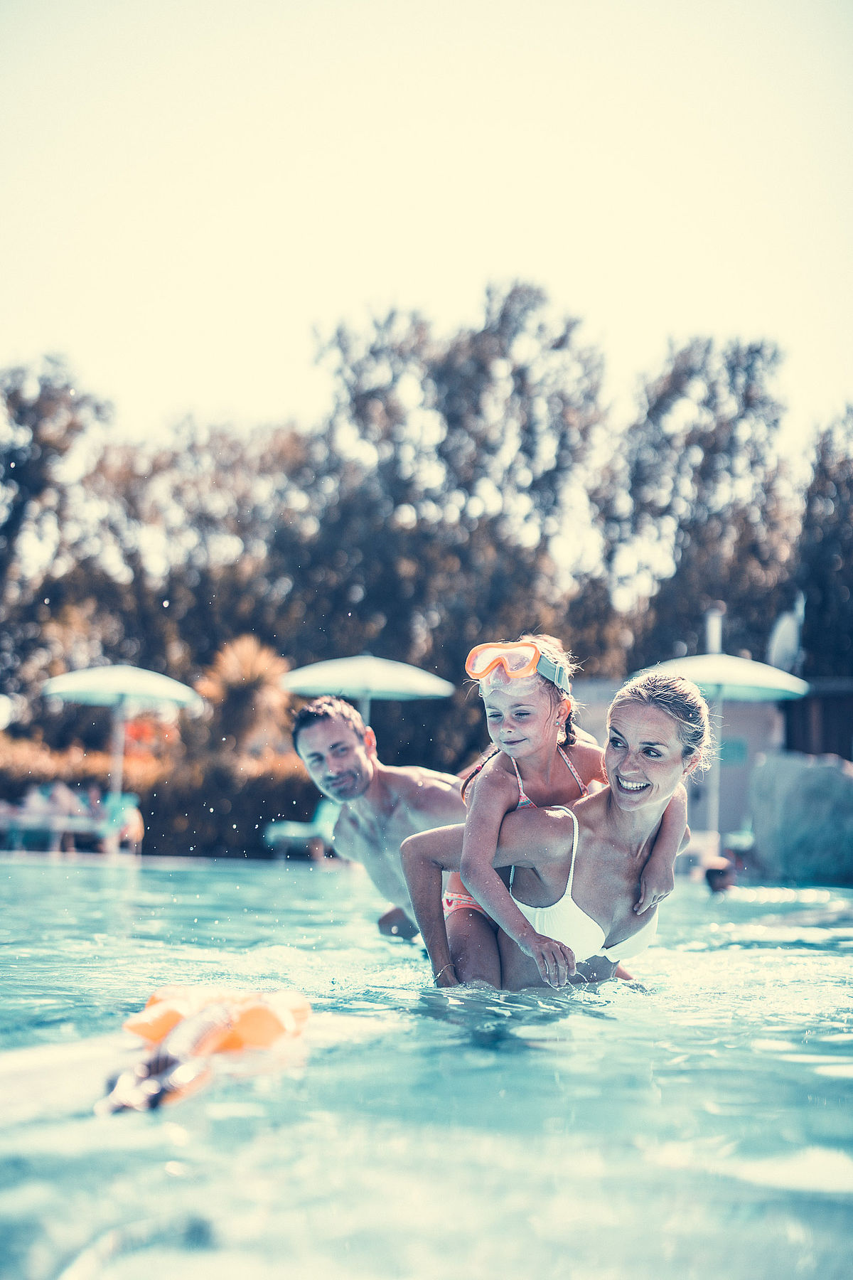 Mother and daughter playing in the pool