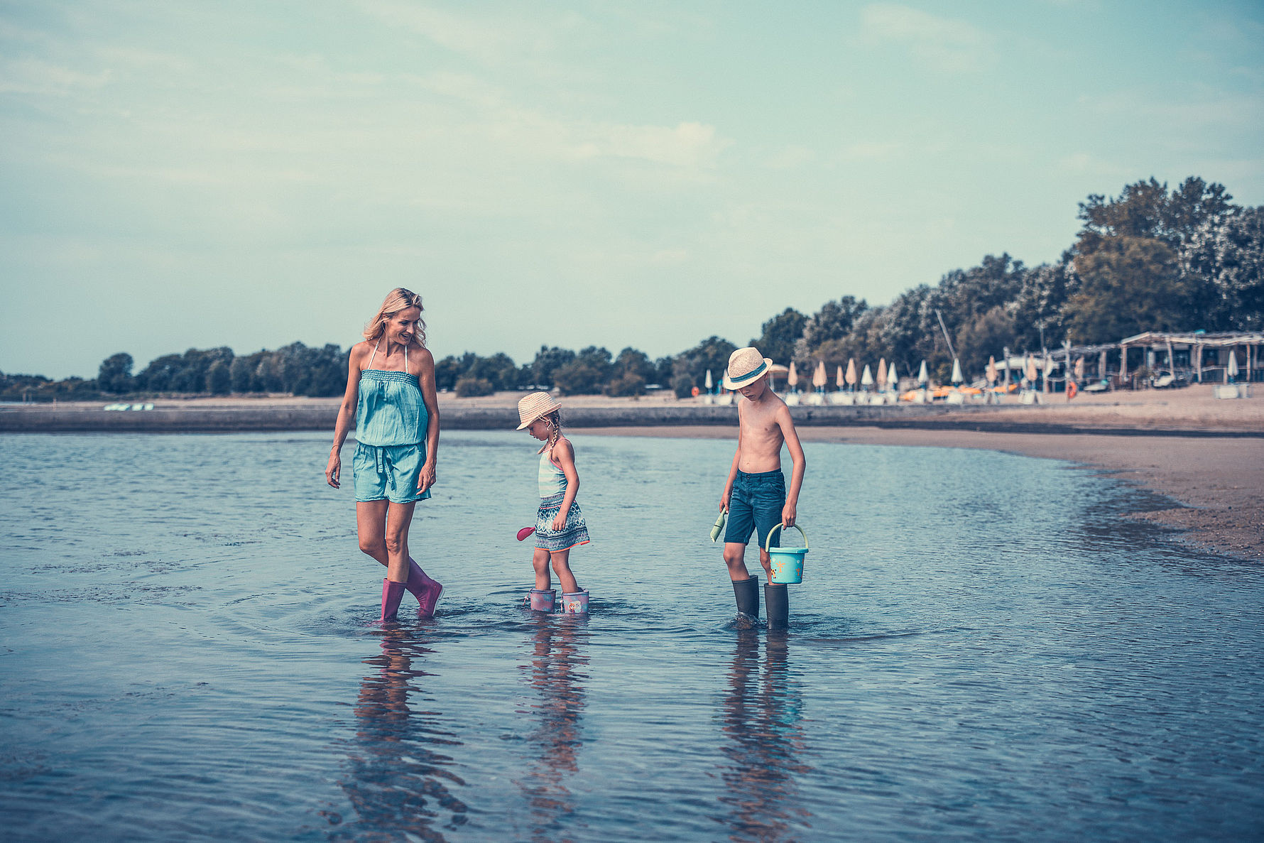 Mother and children looking for crabs in the mudflats
