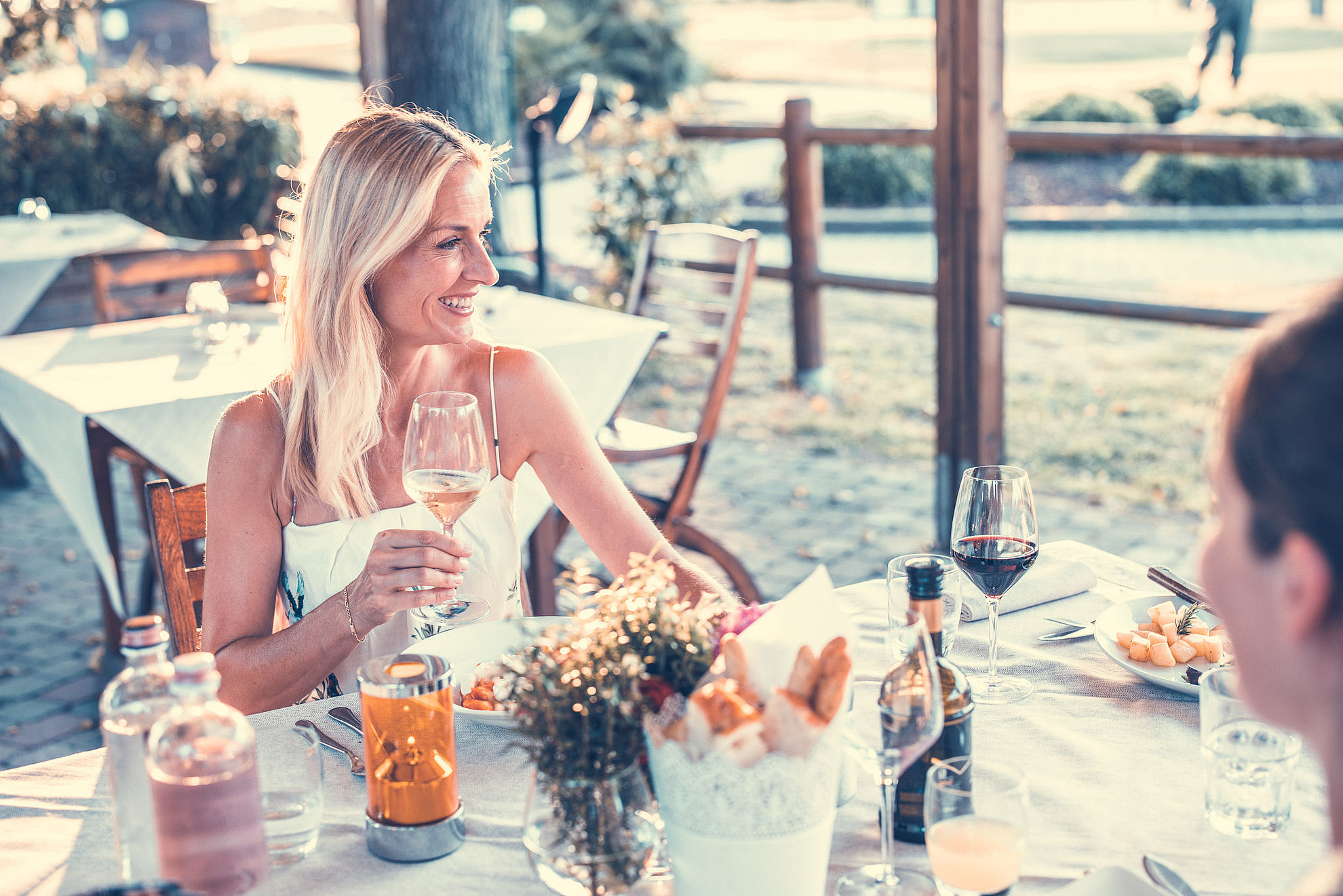 Blonde woman drinking white wine